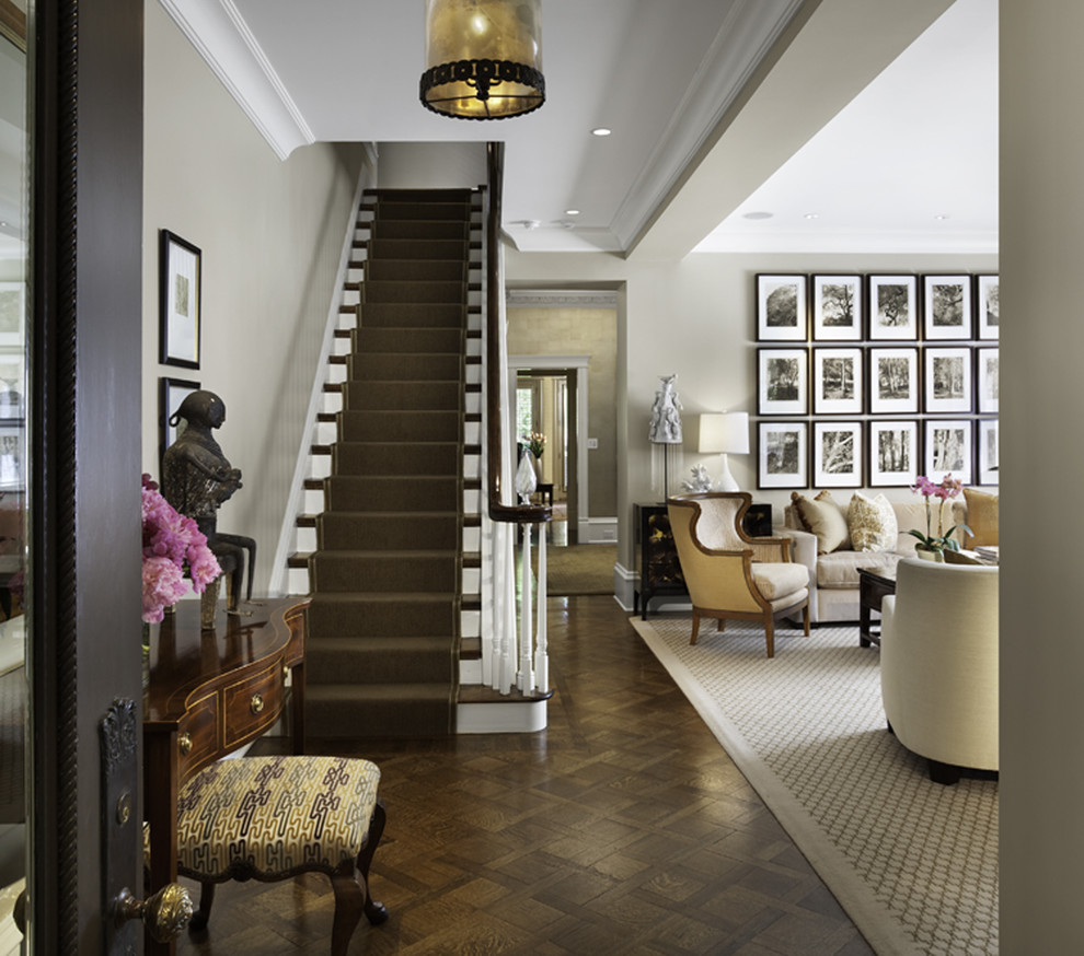 Photo of a classic entrance in Chicago with grey walls and dark hardwood flooring.