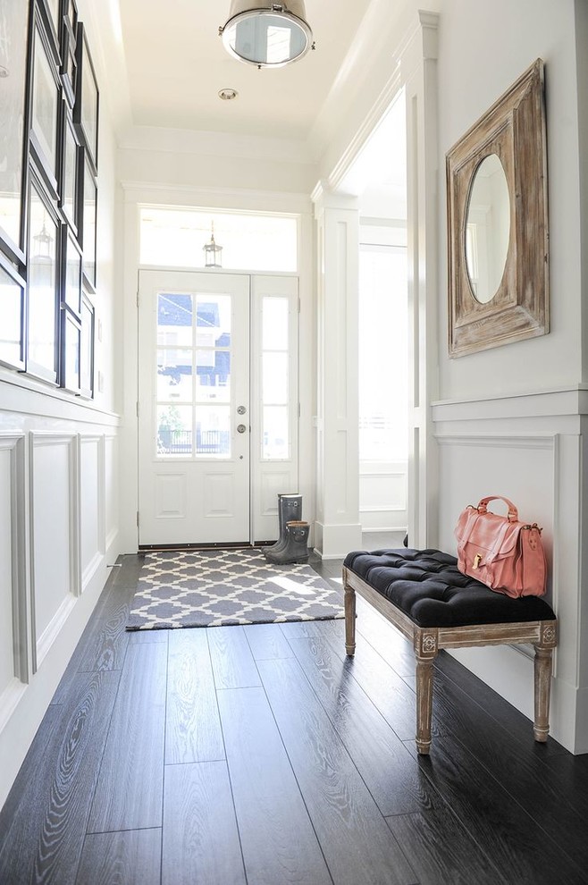 Photo of a medium sized contemporary front door in New York with white walls, laminate floors, a single front door and a white front door.