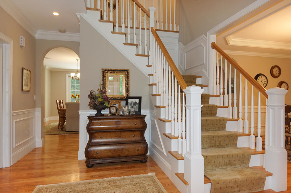 Example of a large classic light wood floor foyer design in Boston with beige walls