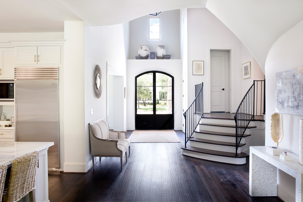 Geräumiges Klassisches Foyer mit weißer Wandfarbe, dunklem Holzboden, Doppeltür, braunem Boden und Haustür aus Glas in Houston