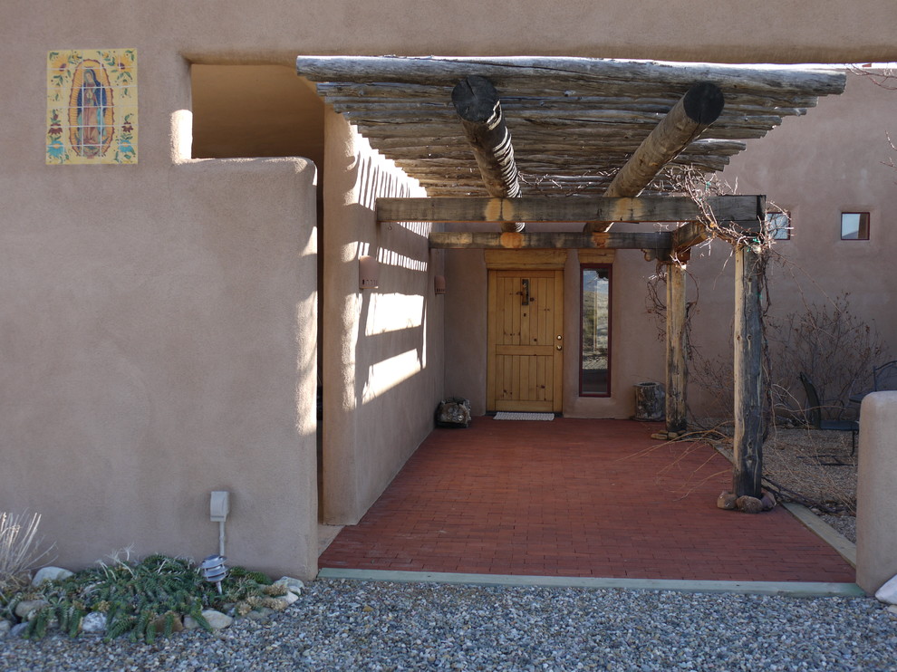 Inspiration for a mid-sized timeless entryway remodel in Albuquerque with beige walls and a light wood front door