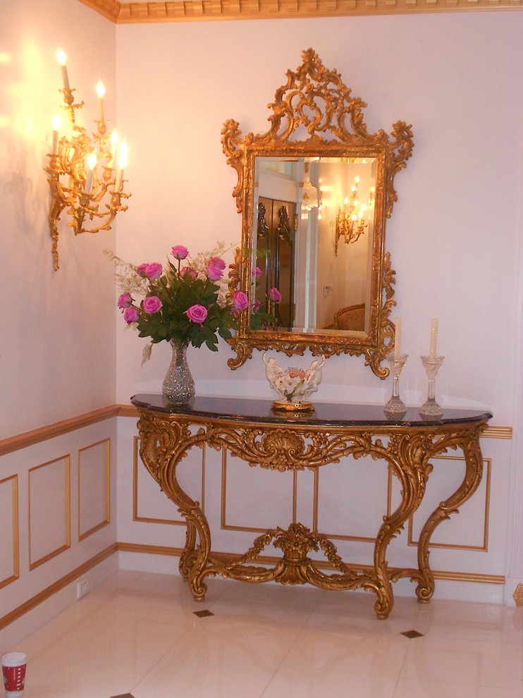 Example of a mid-sized classic foyer design in New York with white walls