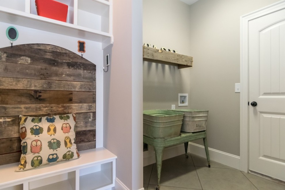 This is an example of a medium sized rustic boot room in Raleigh with grey walls, porcelain flooring, a single front door, a white front door and grey floors.