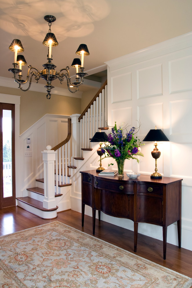 Foyer - large traditional medium tone wood floor and brown floor foyer idea in Richmond with beige walls