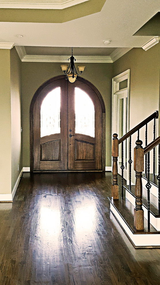 Inspiration for a large classic foyer in Charleston with grey walls, dark hardwood flooring, a double front door and a medium wood front door.