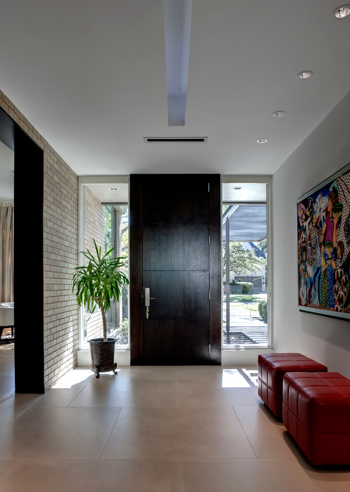 Inspiration for a contemporary front door in Dallas with a dark wood front door.
