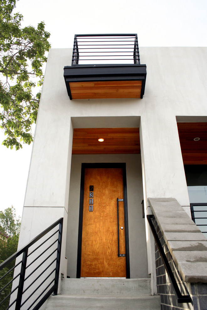 Inspiration for a medium sized modern front door in Denver with white walls, concrete flooring, a single front door and a medium wood front door.