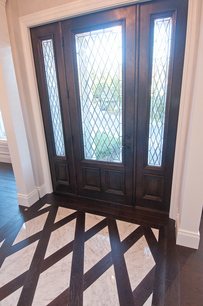 Inspiration for a mid-sized timeless marble floor entryway remodel in Portland with gray walls and a dark wood front door
