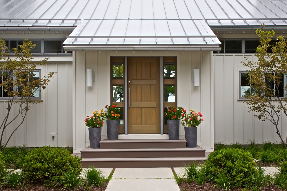 Design ideas for a contemporary front door in Grand Rapids with a single front door and a medium wood front door.
