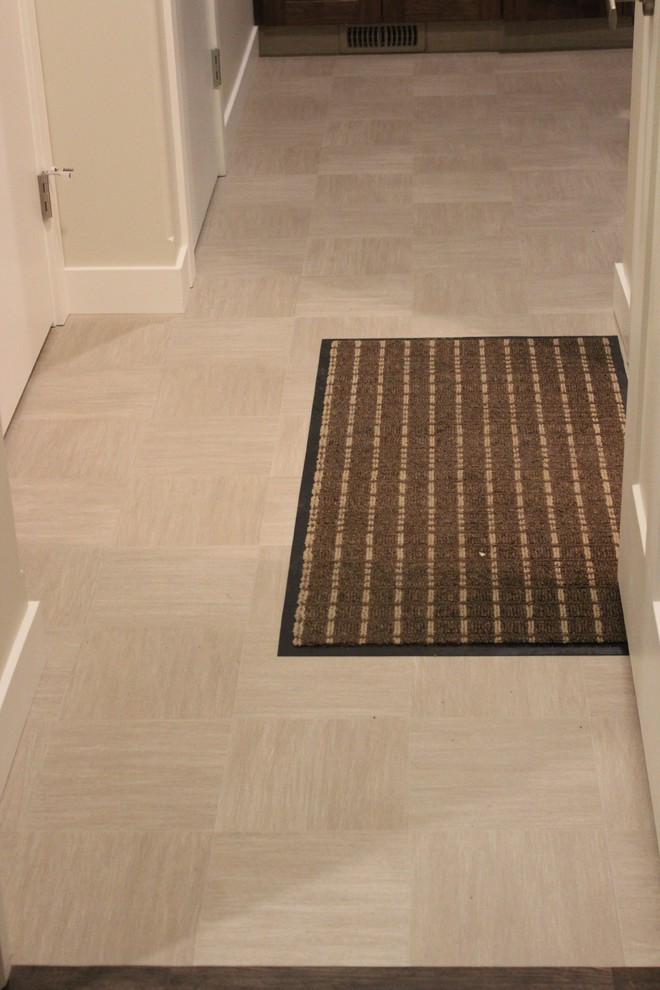 Inspiration for a mid-sized contemporary vinyl floor mudroom remodel in Calgary with beige walls