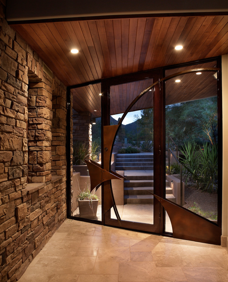 Example of a trendy single front door design in Phoenix with a glass front door