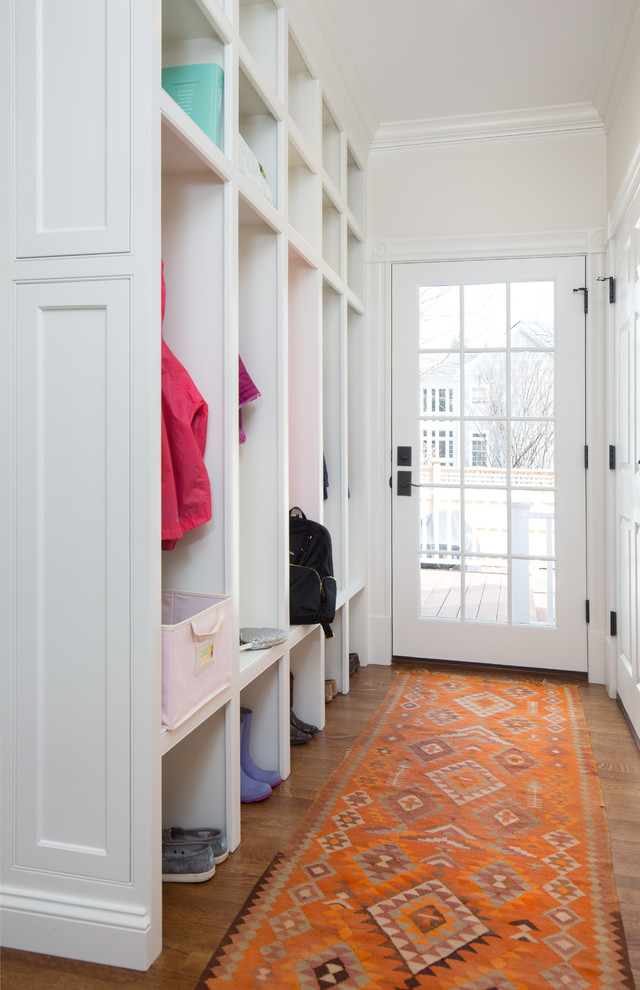 Design ideas for a medium sized classic boot room in Boston with white walls, medium hardwood flooring, a single front door, a white front door and brown floors.