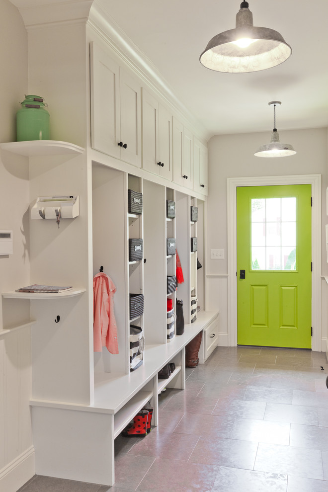 Example of a classic entryway design in Boston with white walls and a green front door