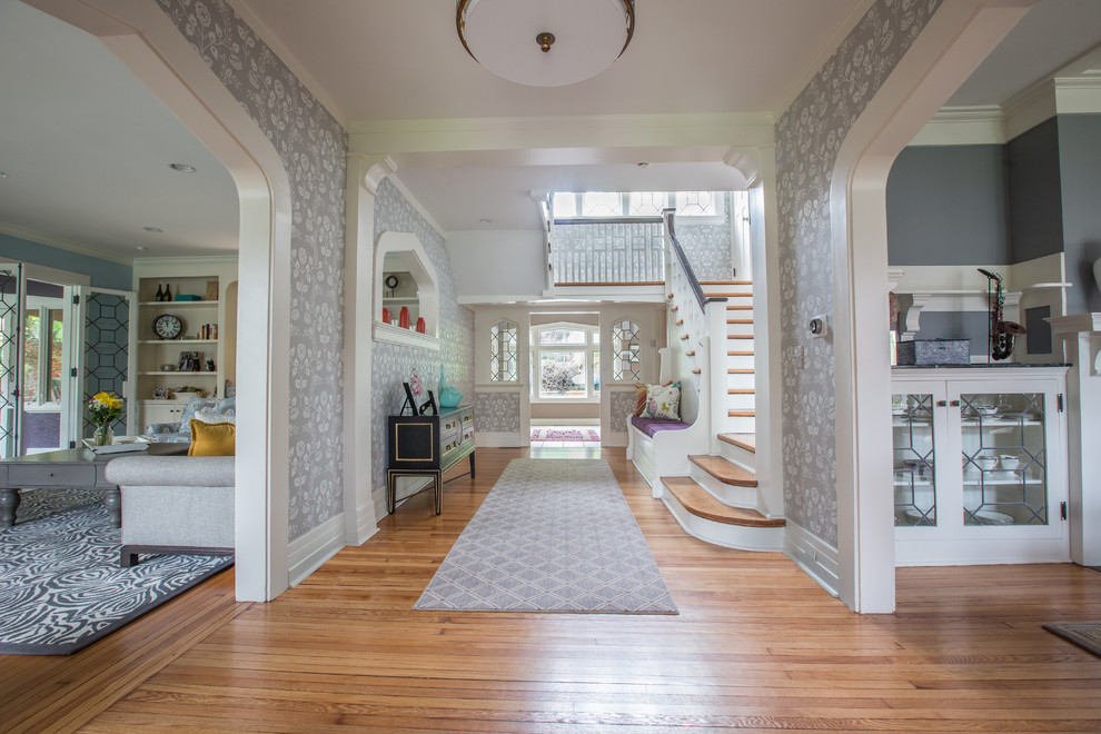 Example of a mid-sized eclectic light wood floor and brown floor entry hall design in Los Angeles with gray walls