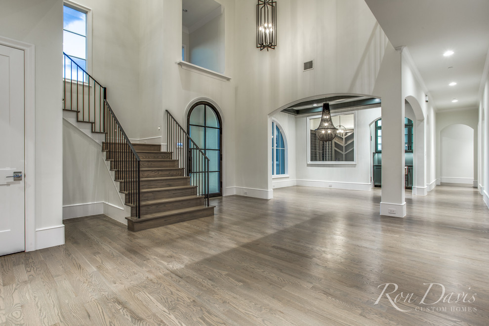 Example of a large tuscan medium tone wood floor and brown floor entryway design in Dallas with a blue front door