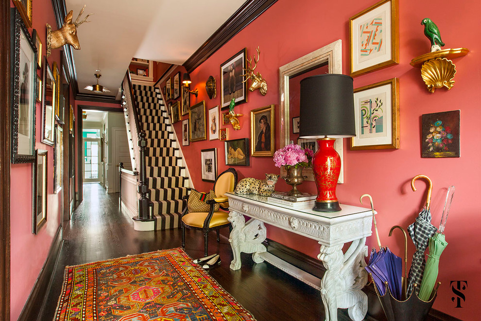 This is an example of an expansive eclectic foyer in Chicago with pink walls, dark hardwood flooring, a single front door and a dark wood front door.