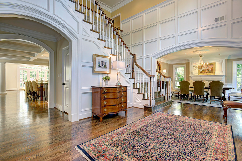 Photo of a large classic foyer in DC Metro with white walls and medium hardwood flooring.