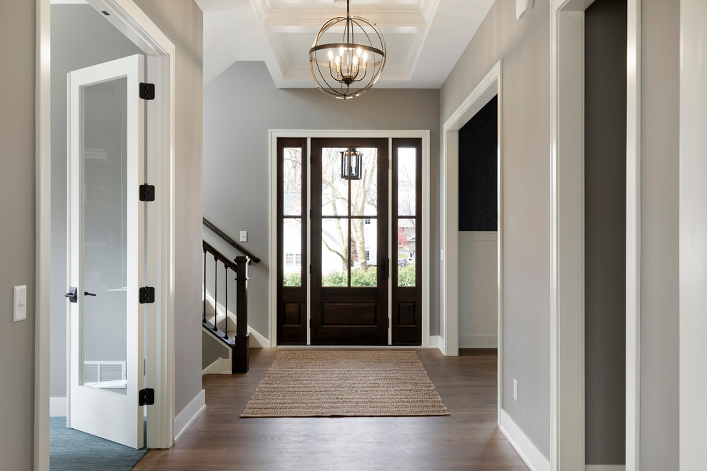 Mid-sized transitional medium tone wood floor and beige floor entryway photo in Minneapolis with gray walls and a dark wood front door