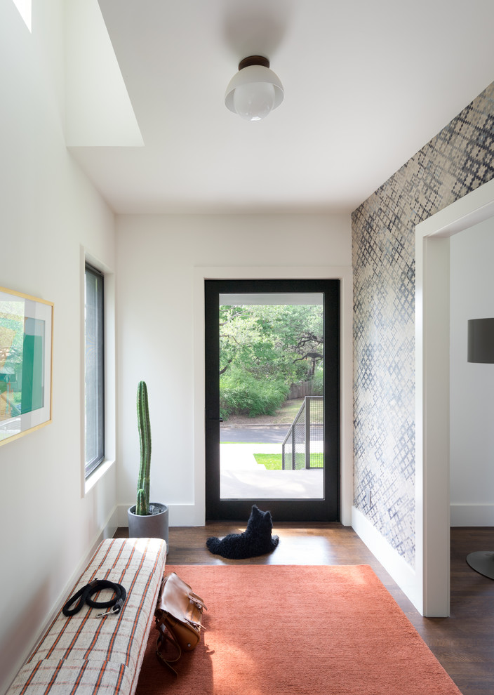 Immagine di una porta d'ingresso classica di medie dimensioni con pareti bianche, pavimento in legno massello medio, una porta singola, una porta in metallo e pavimento marrone