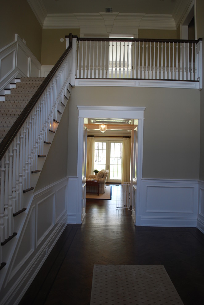 Inspiration for a large traditional hallway in New York with dark hardwood flooring and a single front door.