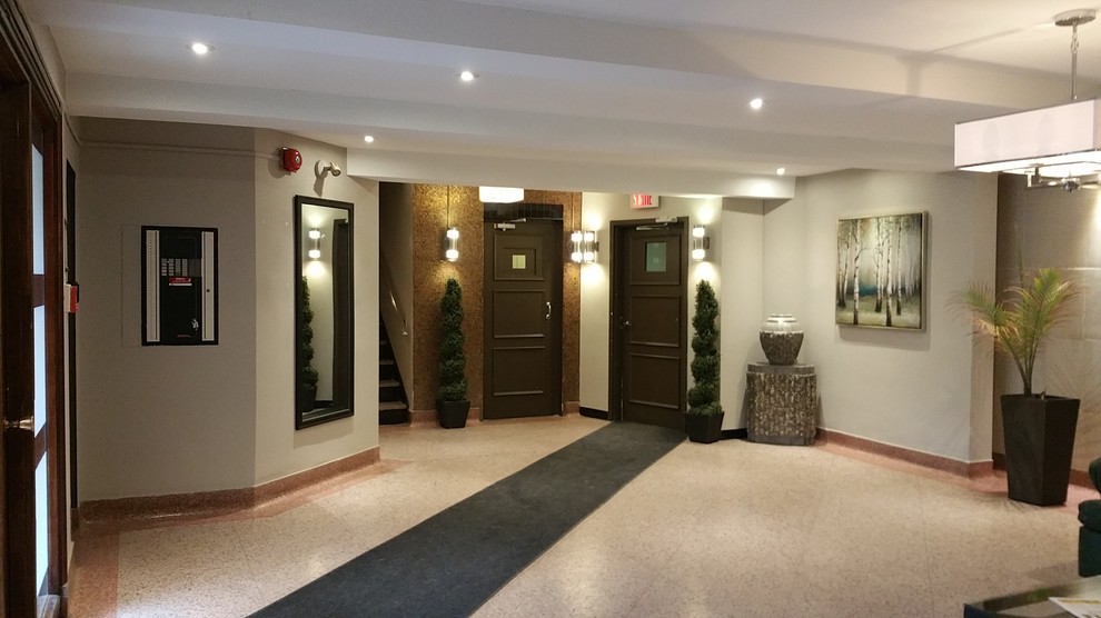 Design ideas for a medium sized contemporary front door in Montreal with beige walls, laminate floors and beige floors.