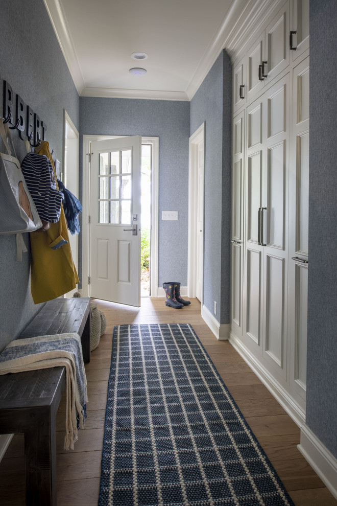 Photo of a medium sized traditional hallway in Minneapolis with black walls, medium hardwood flooring, a single front door, a white front door and beige floors.