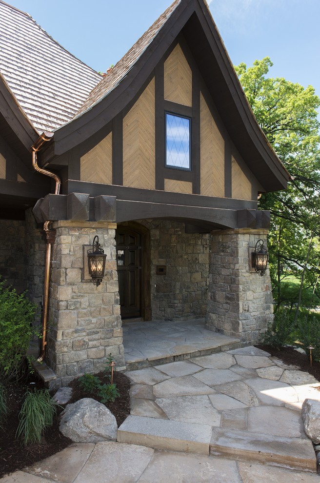 Inspiration for a timeless entryway remodel in Minneapolis with a medium wood front door