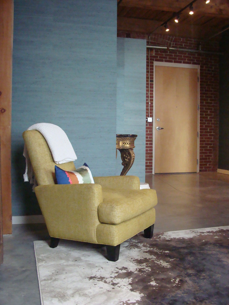 Example of a mid-sized eclectic concrete floor entryway design in St Louis with blue walls and a light wood front door