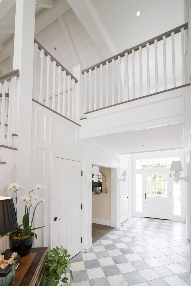Inspiration for a large cottage entryway remodel in Los Angeles with white walls and a white front door