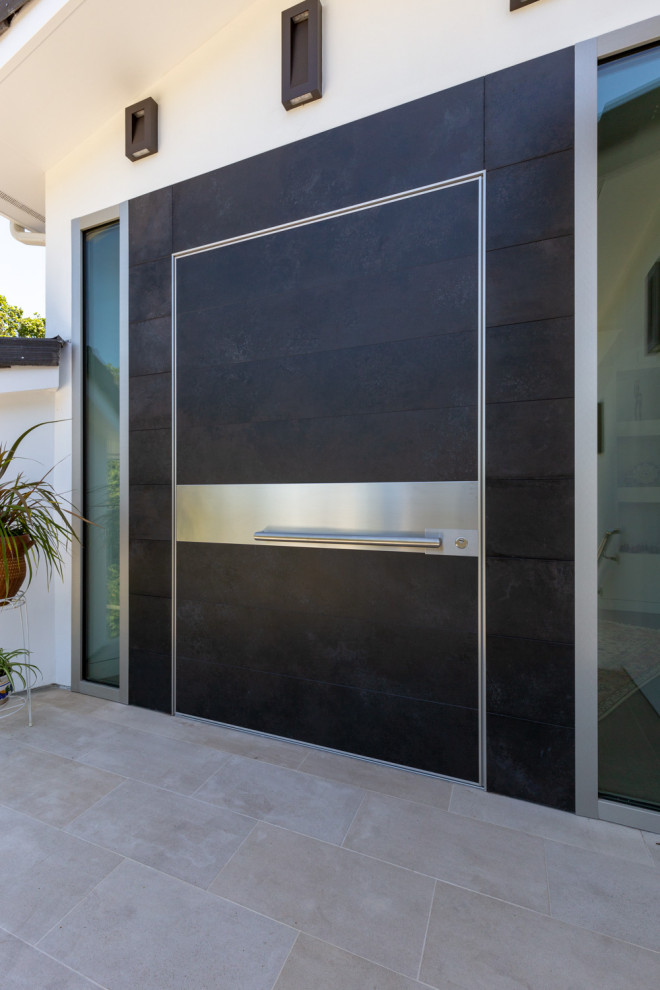 Photo of a large modern front door in San Francisco with grey walls, a pivot front door and a black front door.