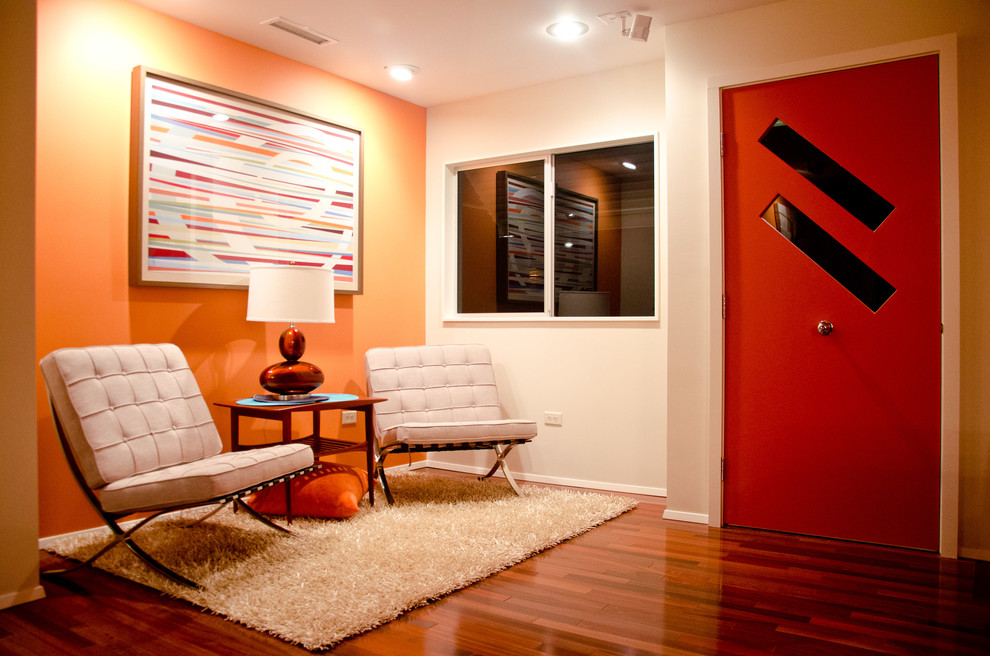 Photo of a midcentury front door in Los Angeles with a single front door, a red front door and feature lighting.