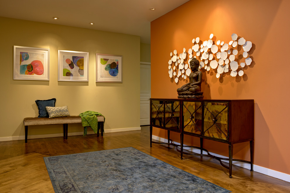 Mid-sized transitional medium tone wood floor and brown floor foyer photo in San Francisco with orange walls
