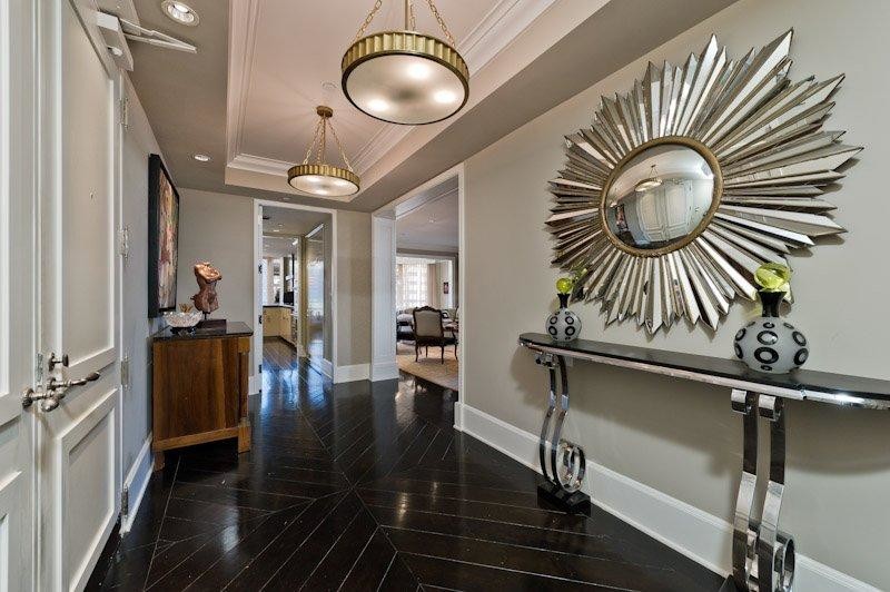 This is an example of a medium sized contemporary foyer in Los Angeles with beige walls, dark hardwood flooring, a double front door and a white front door.