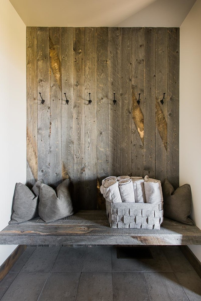 This is an example of a rustic entrance in Austin with beige walls and grey floors.