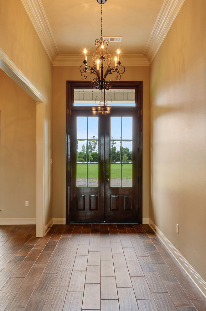Immagine di una porta d'ingresso chic con pareti beige, pavimento con piastrelle in ceramica, una porta a due ante e una porta in legno scuro