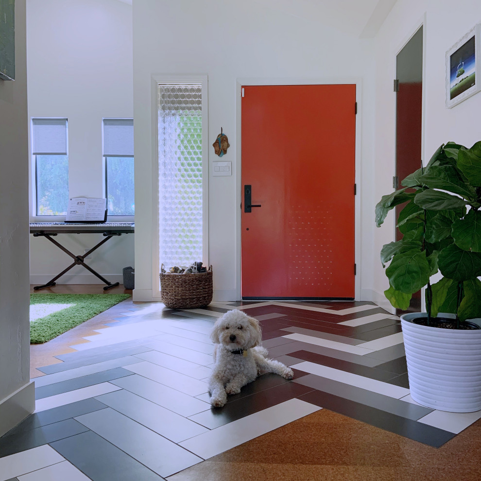 Mid-sized mid-century modern porcelain tile, multicolored floor and vaulted ceiling entryway photo in San Diego with white walls and an orange front door