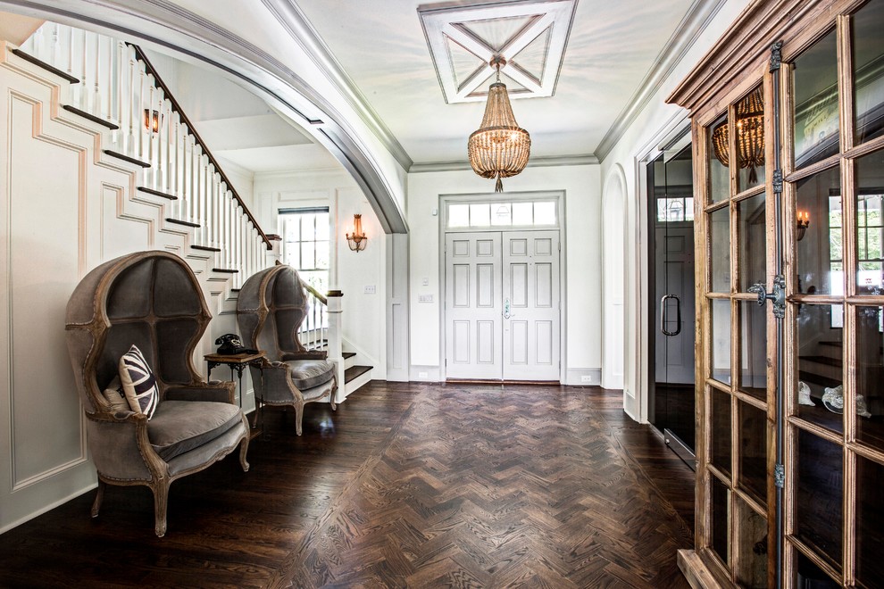 This is an example of a traditional entrance in Atlanta with white walls, dark hardwood flooring, a double front door and a grey front door.