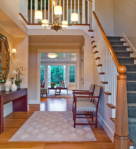 Foyer - mid-sized cottage medium tone wood floor and brown floor foyer idea in Boston with beige walls