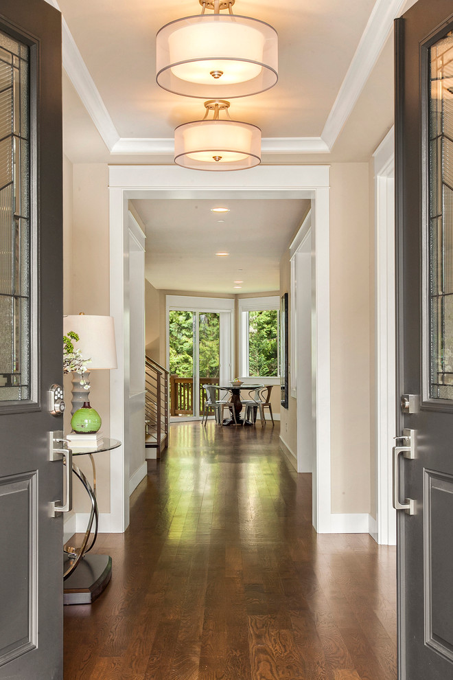 Inspiration for a large transitional dark wood floor entryway remodel in Seattle with beige walls and a gray front door