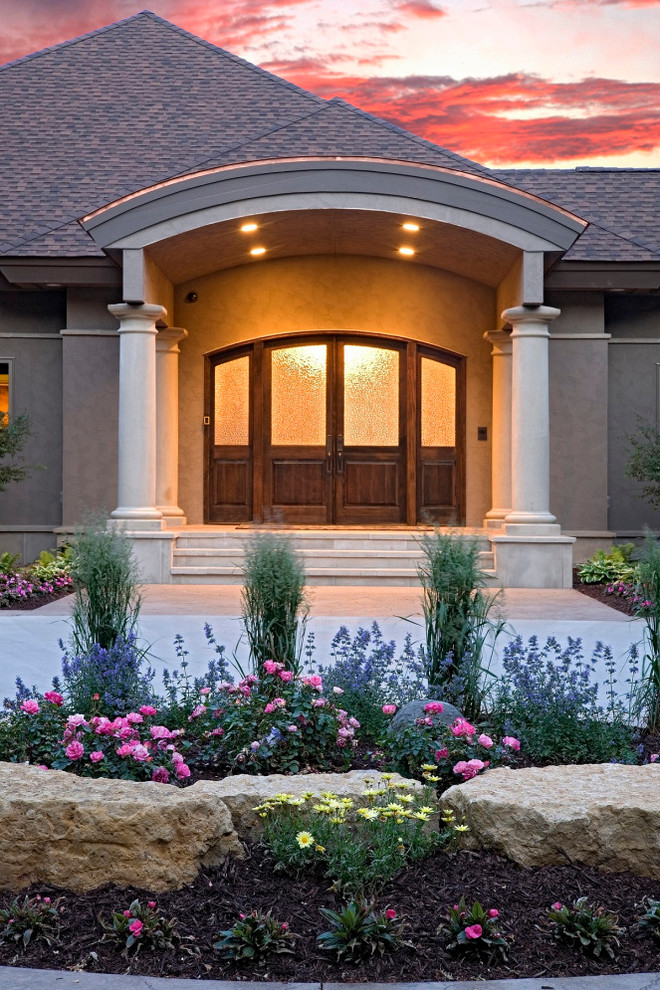 Traditional entrance in Minneapolis with a double front door and a dark wood front door.