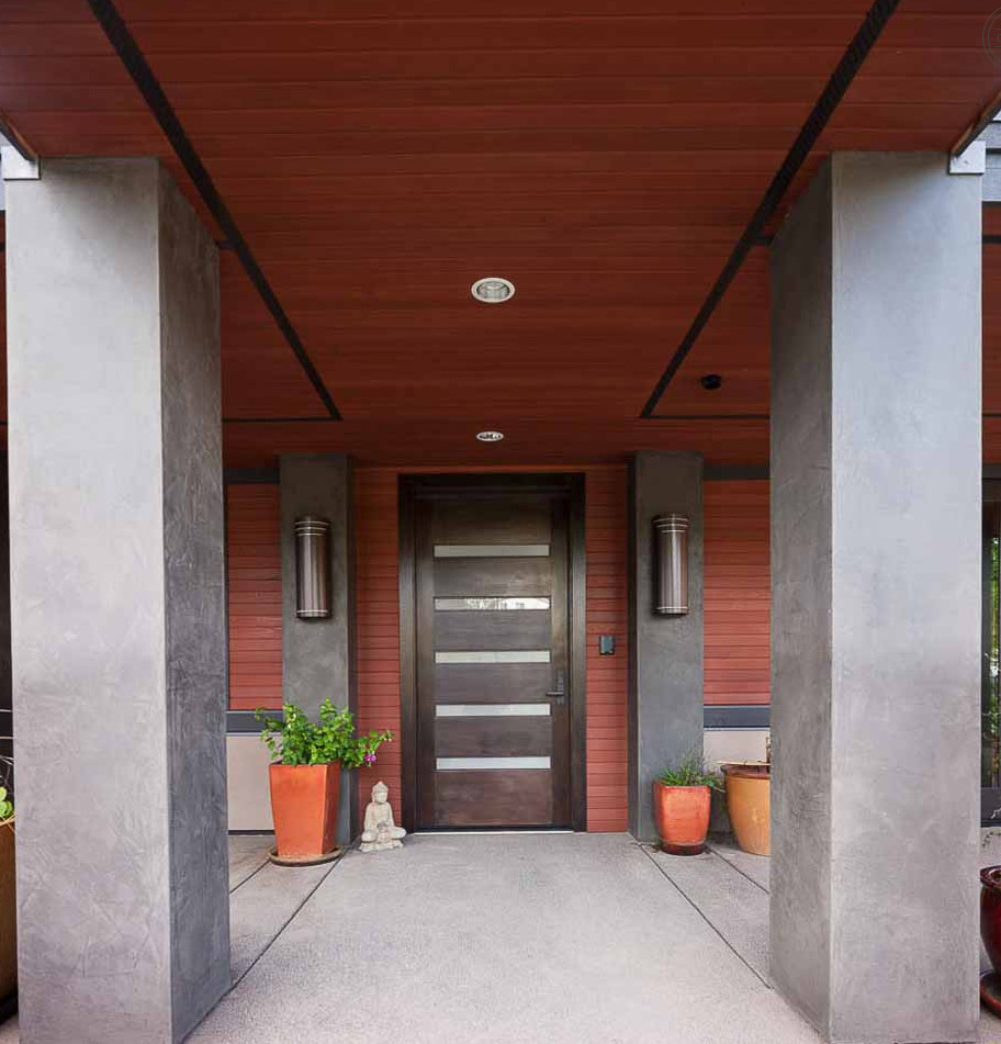Example of a minimalist concrete floor entryway design in Phoenix with a dark wood front door