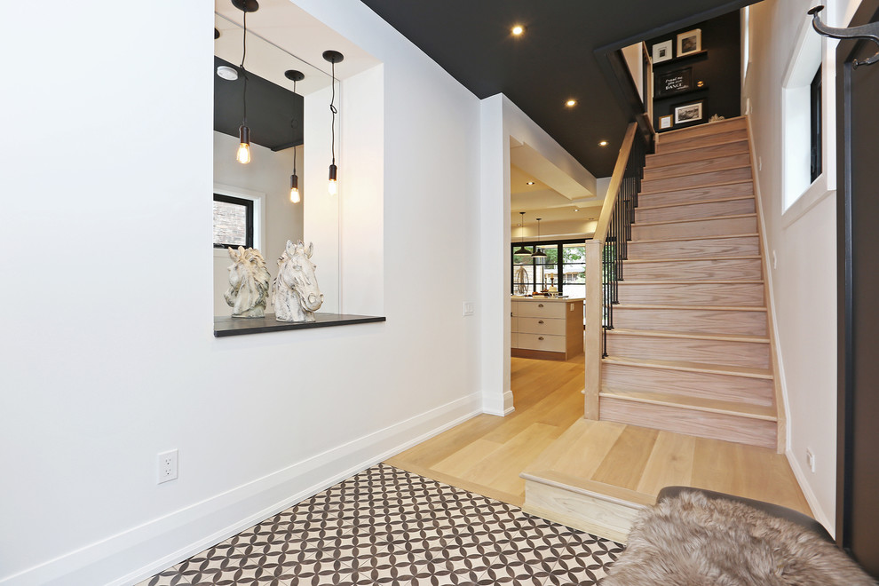 Mid-sized danish ceramic tile entryway photo in Toronto with white walls and a black front door