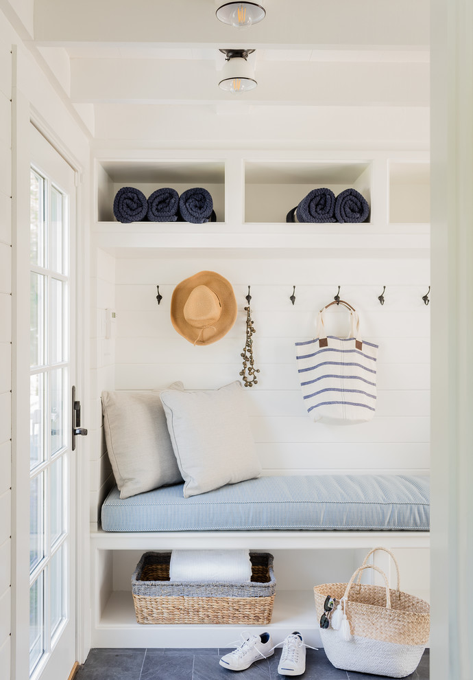 Design ideas for a nautical boot room in Boston with white walls, black floors and feature lighting.