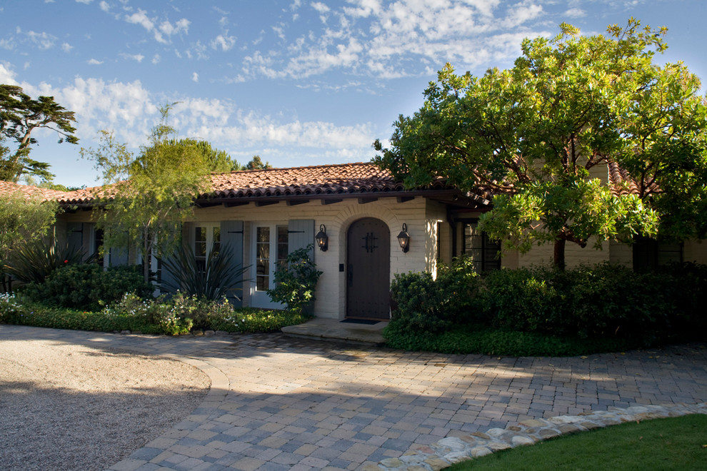 Large tuscan entryway photo in Santa Barbara with white walls and a dark wood front door