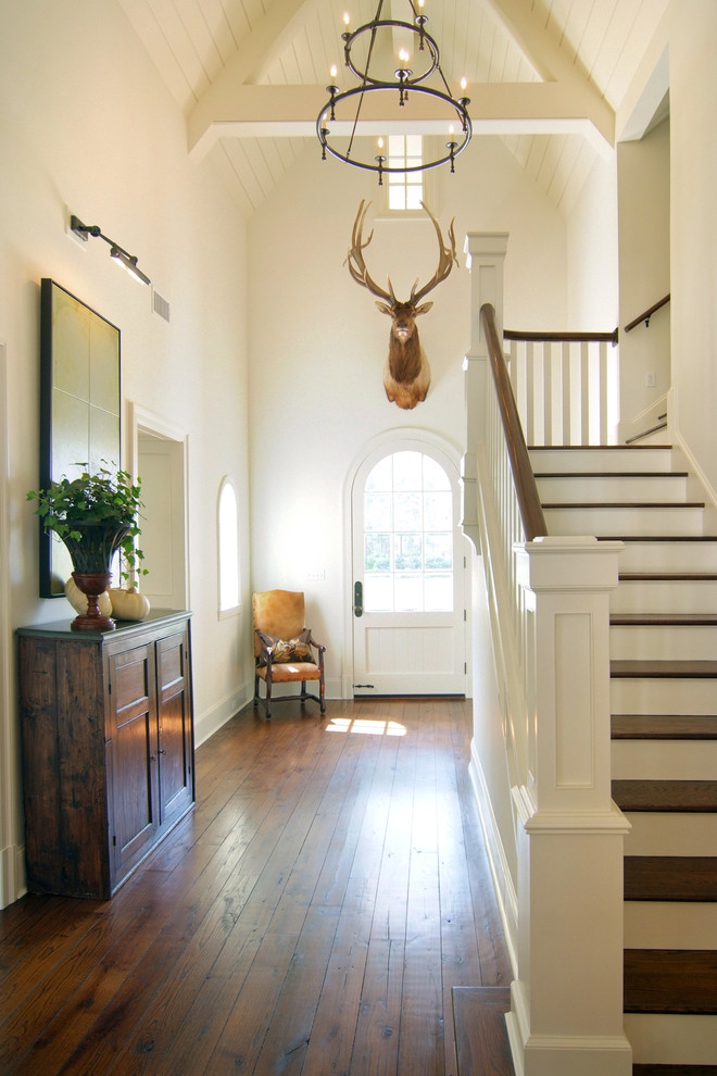 Design ideas for a traditional foyer in New Orleans with beige walls, dark hardwood flooring, a single front door and a white front door.