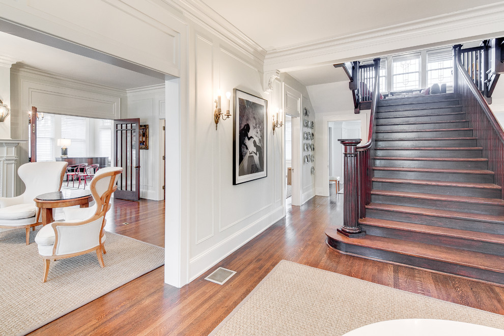 Large traditional foyer in Dallas with white walls and medium hardwood flooring.