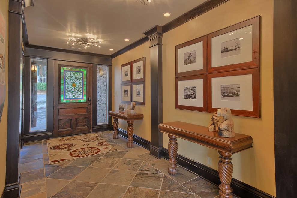 Example of a large classic ceramic tile entryway design in Other with beige walls and a medium wood front door