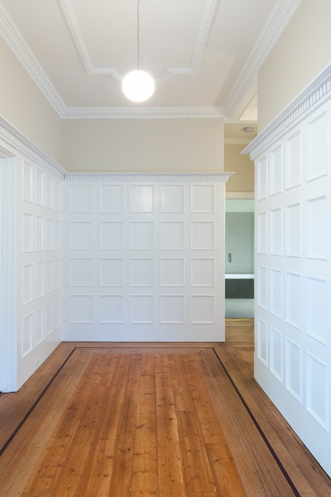 На фото: фойе среднего размера в классическом стиле с белыми стенами, паркетным полом среднего тона и одностворчатой входной дверью