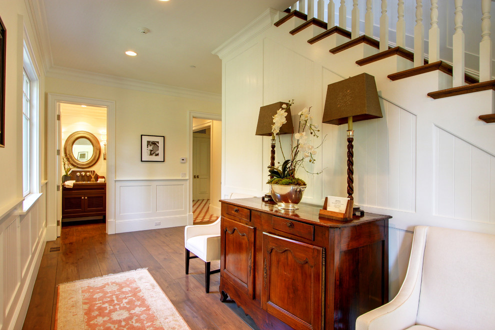 Design ideas for a traditional entrance in Los Angeles with white walls and medium hardwood flooring.