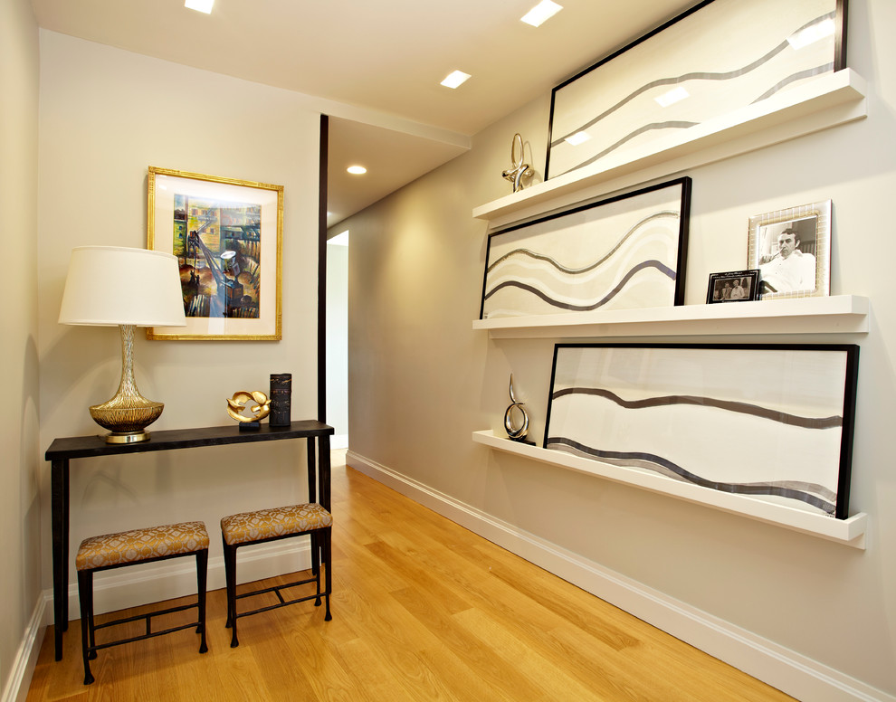 Example of a mid-sized transitional light wood floor entry hall design in Boston with beige walls